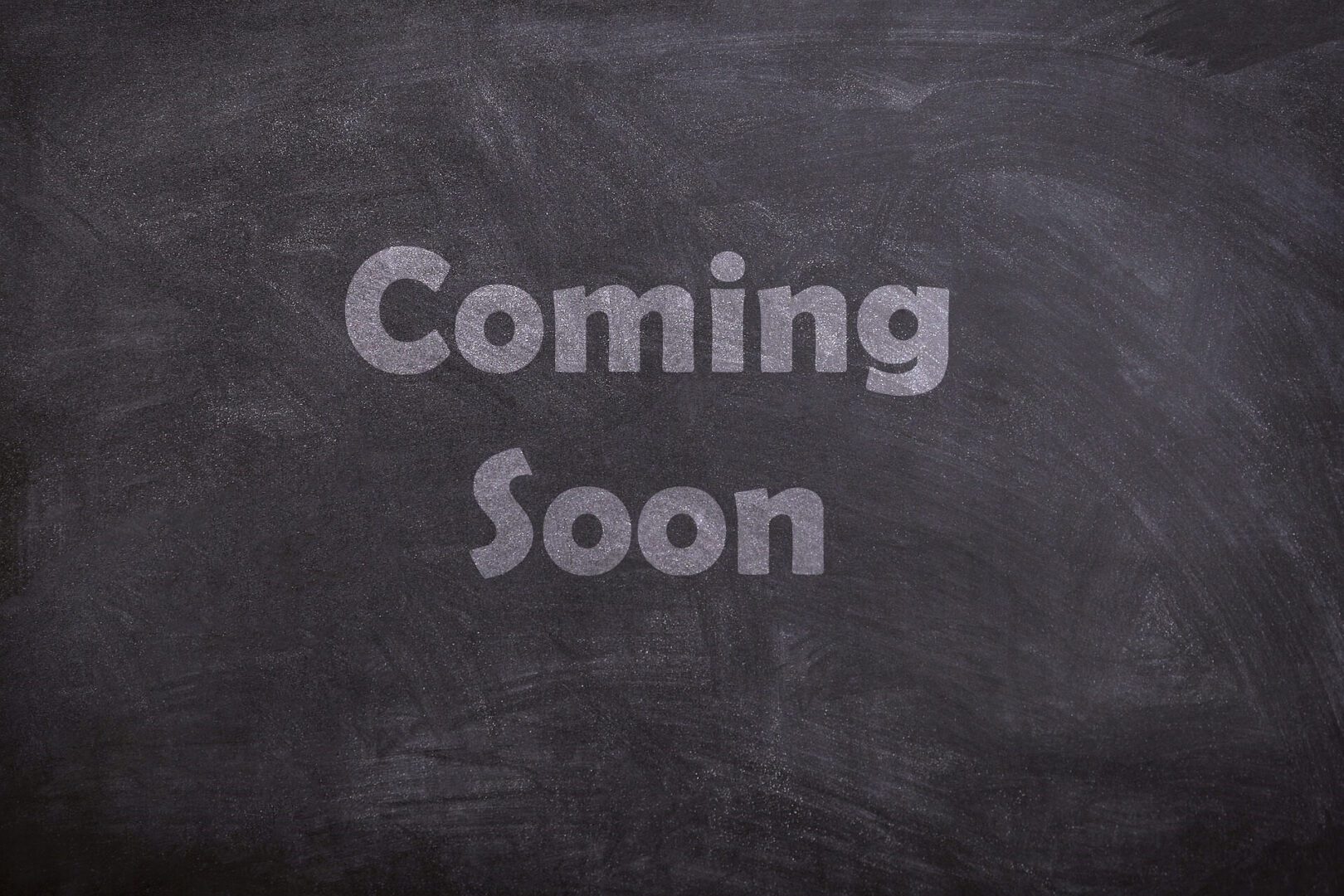 A chalkboard with the words " coming soon ".