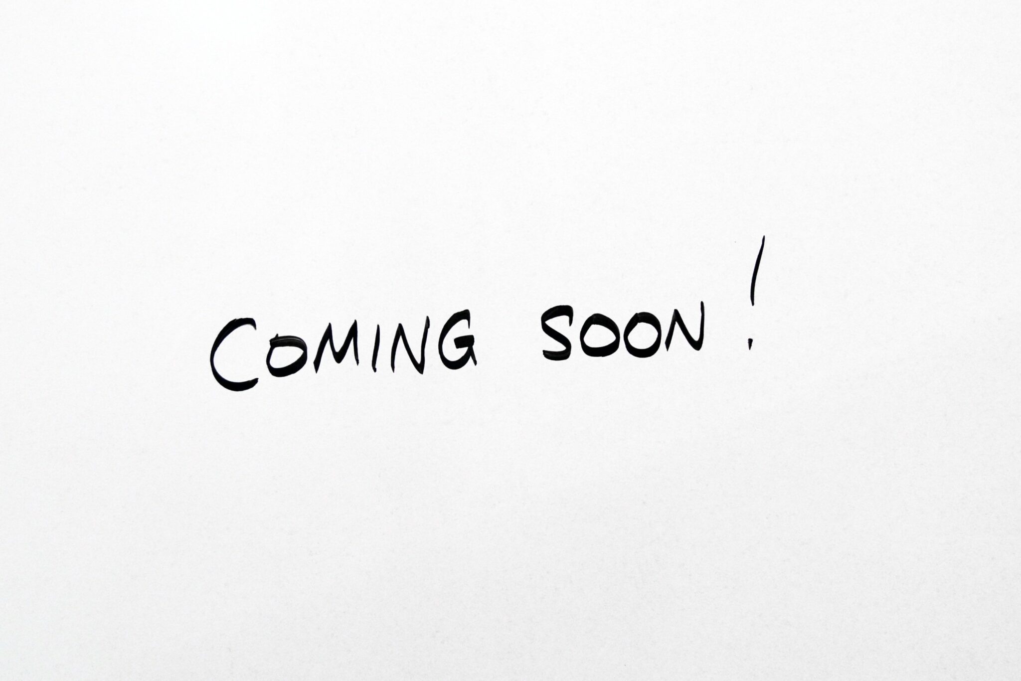 A white sheet with the words " coming soon !" written in black ink.