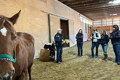 A group of people standing around in an arena.