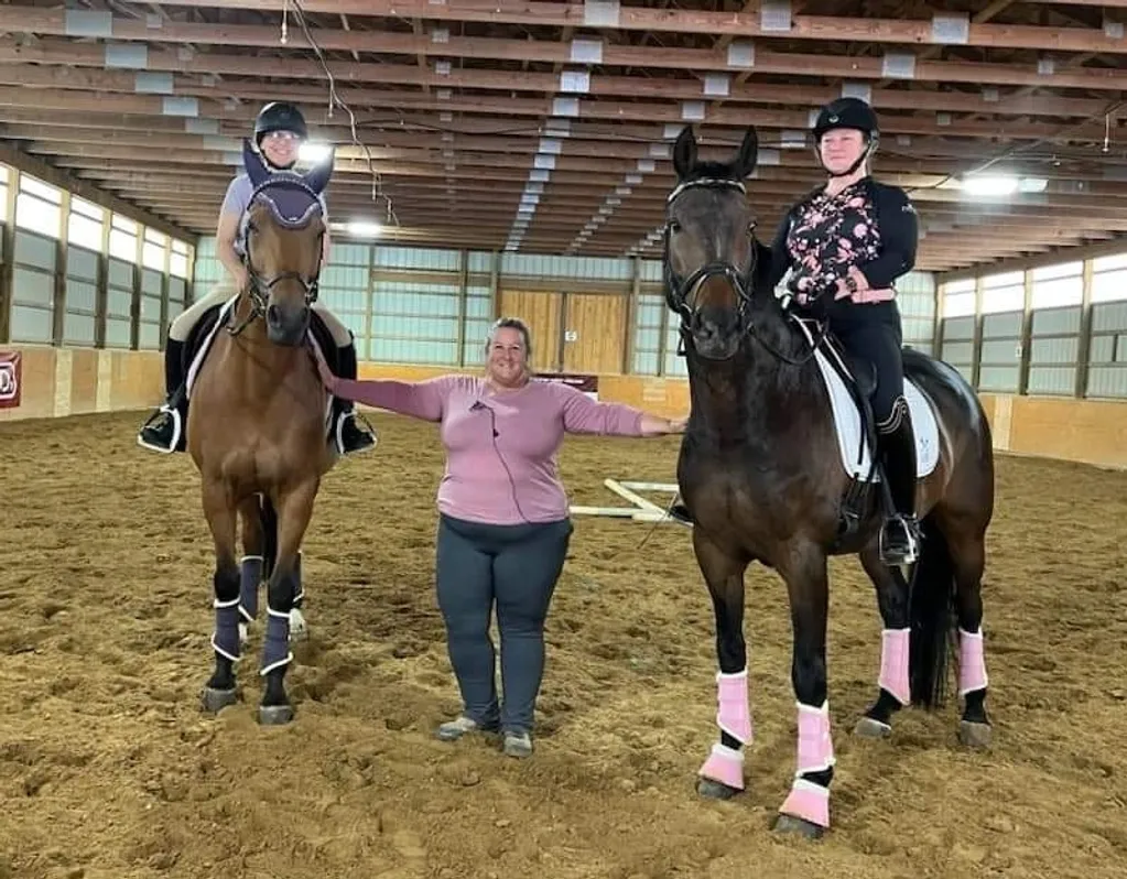 Two girls and a woman are riding horses.