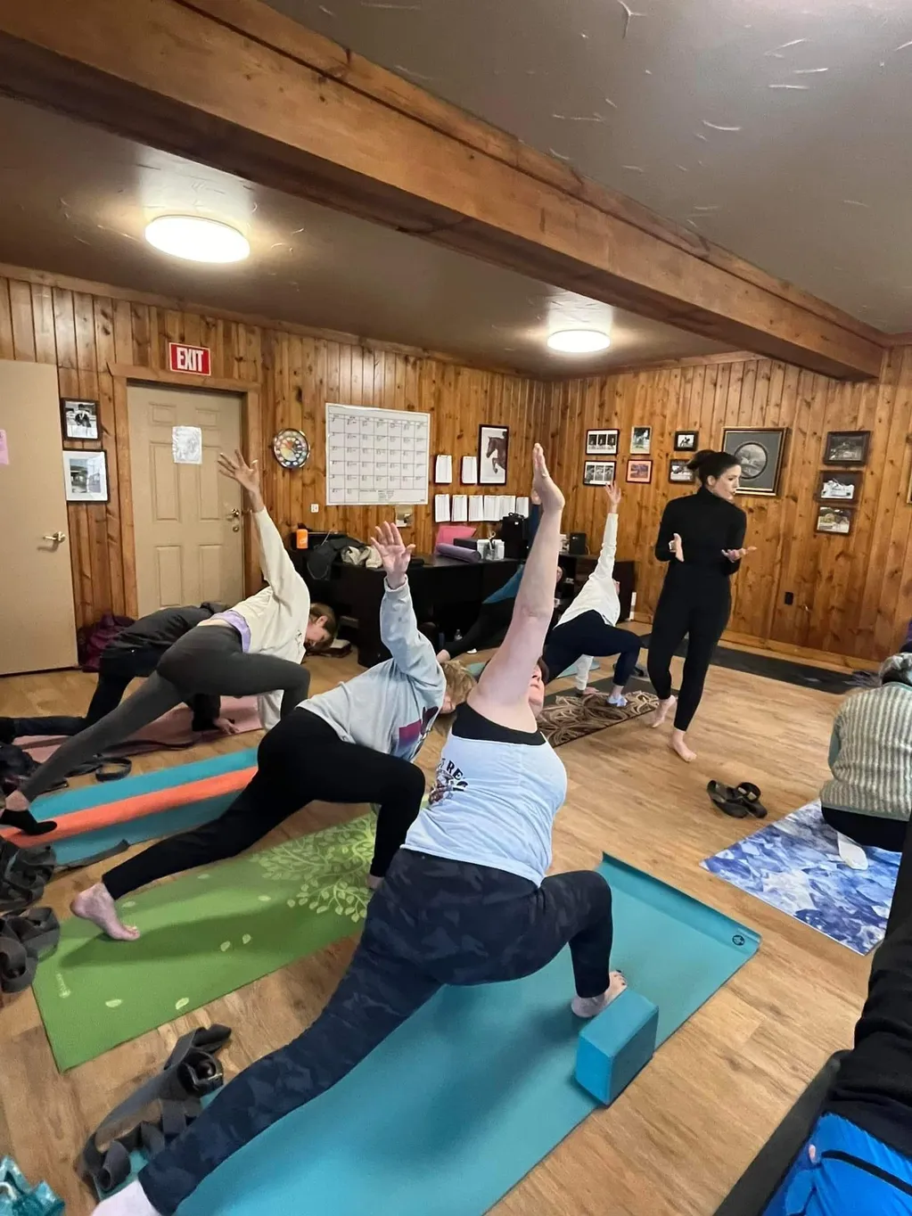 A group of people doing yoga in the gym.