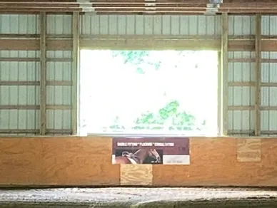 A large room with a window and some wooden walls