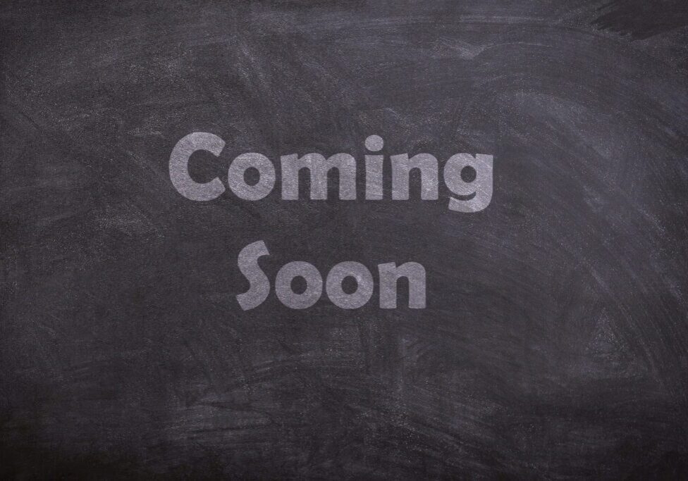 A chalkboard with the words " coming soon ".