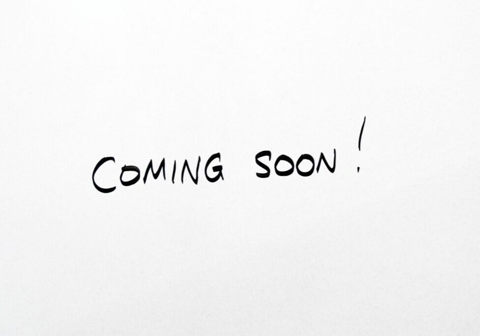 A white sheet with the words " coming soon !" written in black ink.